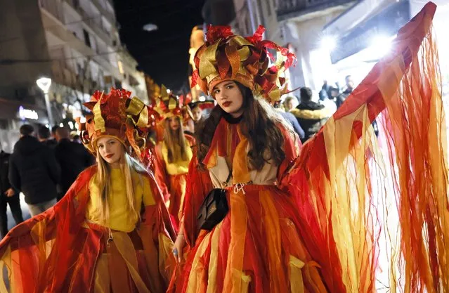 Members of carnival groups perform during a carnival procession of the closing carnival night in the town of Strumica, southeastern North Macedonia, 16 March 2024. North Macedonians are marking Trimery, an Orthodox Christian holiday, when evil spirits are chased away with dance rituals. The holiday marks the beginning of the fasting period ahead of Easter. (Photo by Georgi Licovski/EPA/EFE)