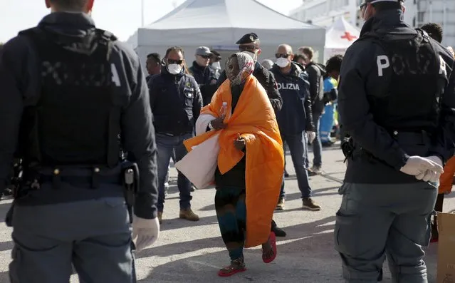 A migrant walks after disembarking from the Norwegian vessel Siem Pilot at Pozzallo's harbour, Italy, March 29, 2016. (Photo by Antonio Parrinello/Reuters)