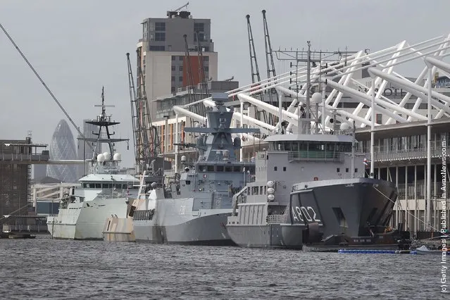 Naval vessels are moored alongside the ExCeL exhibition centre