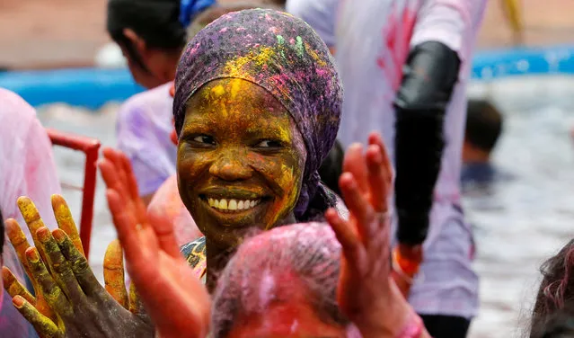 A woman daubed with colour powders takes part in the Hindu Holi Festival celebrated as the Festival of Colours, Love, and Spring in Nairobi, Kenya on March 24, 2024. (Photo by Thomas Mukoya/Reuters)