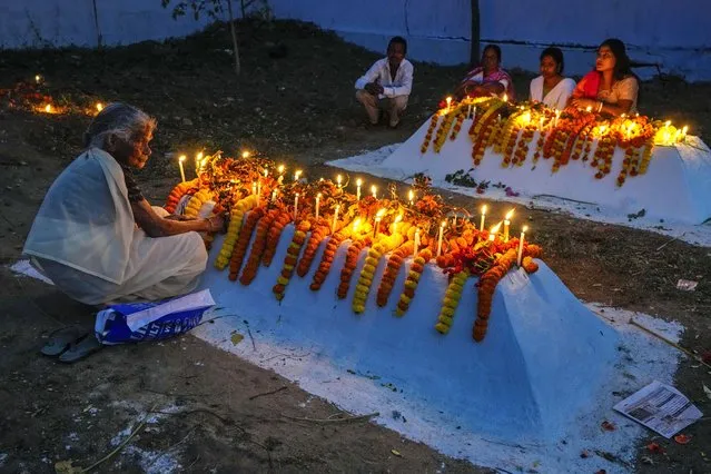 Christian families light candles and put flowers on the graves of their dear ones early morning on Easter in Purulia, West Bengal, India, Sunday, March 31, 2024. (Photo by Bikas Das/AP Photo)