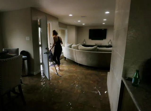 Meital Harari cleans water out of her Meyerland home, Monday, April 18, 2016, in Houston. Her family rode out the storm at a nearby house because her daughter has nightmares from the Memorial Day floods. Massive flooding has become nearly an annual rite of passage in Houston, which is grappling with destroyed homes, trapped drivers and deaths for the third straight year. (Photo by Jon Shapley/Houston Chronicle via AP Photo)