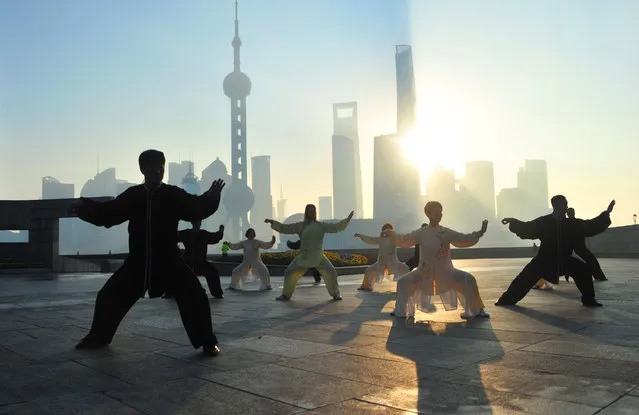 People practice Tai Chi at the Bund in the morning on January 3, 2022 in Shanghai, China. (Photo by Yang Jianzheng/VCG via Getty Images)