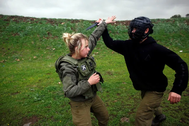 A female Israeli soldier from the Haraam artillery battalion takes part in a training session in Krav Maga, an Israeli self-defence technique, at a military base in the Israeli-occupied Golan Heights March 1, 2017. (Photo by Nir Elias/Reuters)