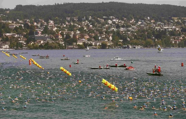 People swim during the annual public Lake Zurich crossing swimming event in Zurich July 1, 2015. (Photo by Arnd Wiegmann/Reuters)