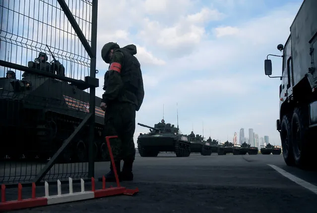 A Russian military vehicle column is seen before a rehearsal for the Victory Day parade, with the Moscow International Business Center also known as “Moskva-City” seen in the background, at a range in Moscow, Russia, May 5, 2016. (Photo by Maxim Shemetov/Reuters)