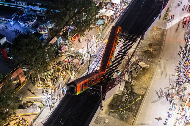 An aerial view of the scene after an elevated section of metro track in Mexico City, carrying train cars with passengers, collapsed onto a busy road on May 03, 2021 in Mexico City, Mexico. The Line 12 accident happened as the metro train was traveling between Olivos and Tezonco Metro stations, reportedly killing at least 20 people and injuring further 70. (Photo by Hector Vivas/Getty Images)