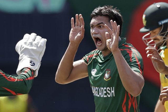 Bangladesh's Taskin Ahmed celebrates the dismissal of South Africa's captain Aiden Markram, partly seen on right, during the ICC Men's T20 World Cup cricket match between Bangladesh and South Africa at the Nassau County International Cricket Stadium in Westbury, New York, Monday, June 10, 2024. (Photo by Adam Hunger/AP Photo)