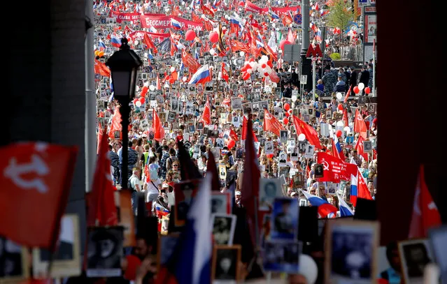 People hold pictures of World War Two soldiers as they take part in the Immortal Regiment march during the Victory Day celebrations, marking the 71st anniversary of the victory over Nazi Germany in World War Two, at Red Square in Moscow, Russia, May 9, 2016. (Photo by Sergei Karpukhin/Reuters)