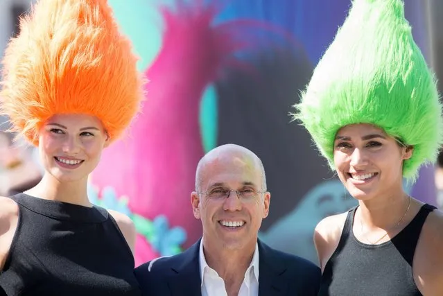 Film producer Jeffrey Katzenberg (C) poses with two models in front of the Brandenburg Gate in Berlin, Germany, 10 May 2016. They presented the upcoming computer-animated film “Trolls” which will hit cinemas across Germany on 13 October 2016. Timberlake served as an executive producer for the film's soundtrack. (Photo by Kay Nietfeld/EPA)