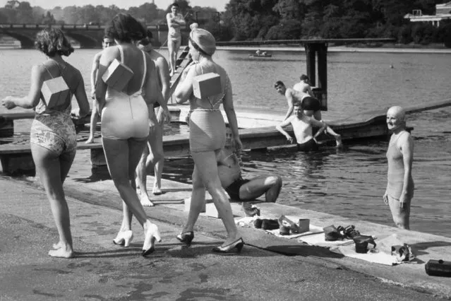 Three women pictured going for a swim in the Serpentine, Hyde Park, London, complete with their gas masks, 1930-1939. (Photo by Keystone/Getty Images)