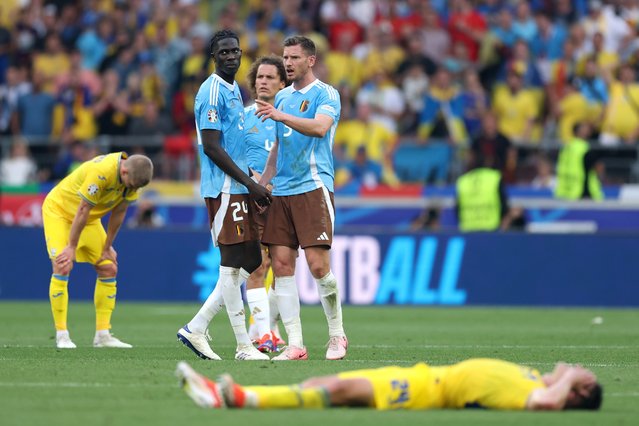 Amadou Onana speaks with Jan Vertonghen of Belgium as players of Ukraine react , as Ukraine are eliminated from EURO 2024 after finishing in fourth place in Group E, after the UEFA EURO 2024 group stage match between Ukraine and Belgium at Stuttgart Arena on June 26, 2024 in Stuttgart, Germany. (Photo by Carl Recine/Getty Images)