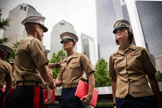 Members of the U.S. Marine Corps are promoted during a ceremony at the National September 11 Memorial on May 23, 2014 in New York City. The ceremony took place in coordination with Fleet Week. (Photo by Andrew Burton/Getty Images)
