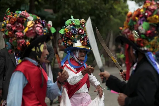Participants of the traditional dance of Los Historiantes perform during the festivity held in honour of Saint James, in Santiago Nonualco July 22, 2015. (Photo by Jose Cabezas/Reuters)