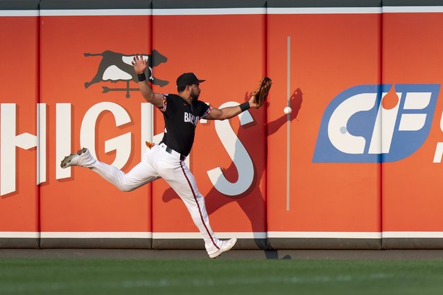 Baltimore Orioles right fielder Anthony Santander is unable to catch a fly ball hit in by Washington Nationals' Alex Call during the second inning of a baseball game, Wednesday, August 14, 2024, in Baltimore. (Photo by Stephanie Scarbrough/AP Photo)