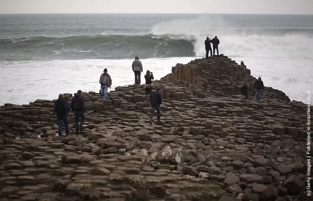 Visitors walk on the Giant's Causway in Portrush, Northern Ireland