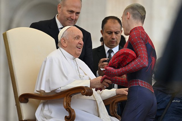 Pope Francis shakes hand with an attendee wearing a costume of US comic books and film superhero Spiderman during the weekly general audience on May 10, 2023 at St. Peter's square in The Vatican. (Photo by Filippo Monteforte/AFP Photo)