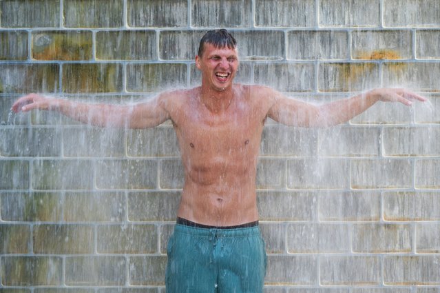 A man refreshes himself at Crown Fountain during a period of hot weather in Chicago, Illinois on August 26, 2024. (Photo by Vincent Alban/Reuters)