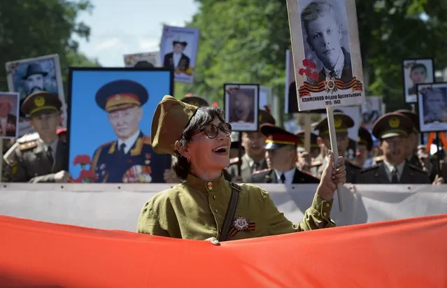 People carry portraits of relatives who fought in World War II, during the Immortal Regiment march in Bishkek, Kyrgyzstan, Monday, May, 9, 2022, marking the 77th anniversary of the end of World War II. (Photo by Vladimir Voronin/AP Photo)