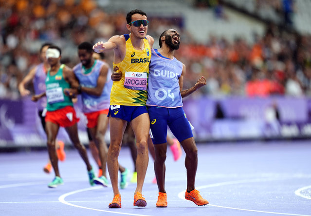 Brazil's Yeltsin Jacques (left) with his guide after winning the Men's 1500m - T11 Final at the Stade de France on day six of the Paris 2024 Summer Paralympic Games on Tuesday, September 3, 2024. (Photo by Zac Goodwin/PA Images via Getty Images)