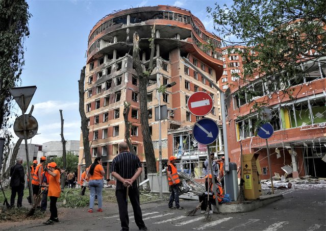 Municipal workers work at a place near a shopping mall damaged by a Russian missile strike, amid Russia's attack on Ukraine, in Odesa, Ukraine on June 14, 2023. (Photo by Serhii Smolientsev/Reuters)