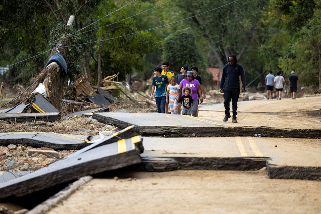 Swannanoa residents walk through devastating flood damage after Hurricane Helene caused widespread flooding, downed trees, and power outages in western North Carolina, September 29, 2024.  (Photo by Travis Long/The News & Observer)