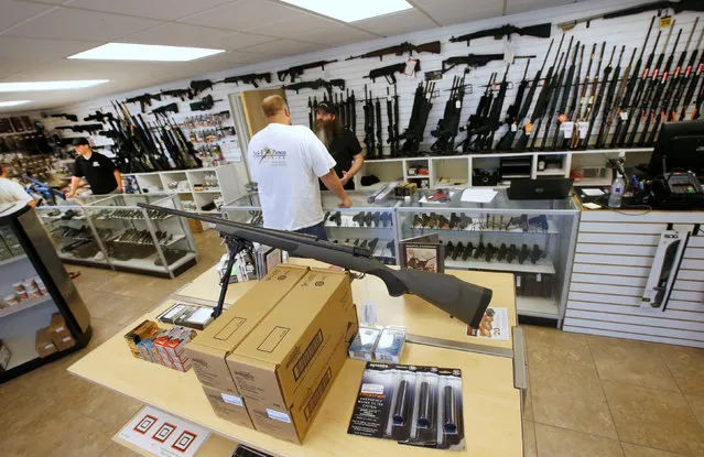 Prospective buyers look at guns at the “Ready Gunner” gun store in Provo, Utah, U.S., June 21, 2016. (Photo by George Frey/Reuters)