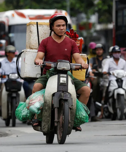 A man transports seafood for sale on a motorcycle on a street in Hanoi, Vietnam June 30, 2016. (Photo by Reuters/Kham)