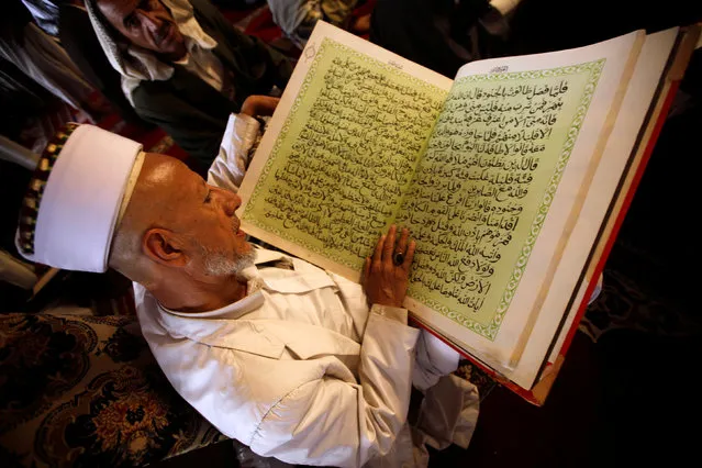 A man reads the Koran at the Grand Mosque during the holy fasting month of Ramadan in Sanaa, Yemen, June 24, 2016. (Photo by Mohamed al-Sayaghi/Reuters)