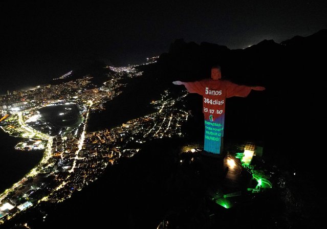 The Climate Clock – which indicates the alleged time left to act to limit global warming to 1.5 degrees Celsius – is projected onto the Christ the Redeemer statue, in Rio de Janeiro, Brazil, on July 22, 2023. (Photo by Carlos Fabal/AFP Photo)