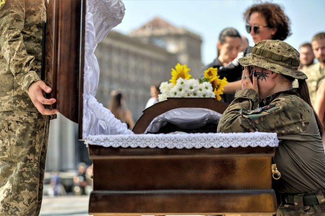 Comrades of late Commander Sergei Ilnitky pay their respects during a memorial service at Independence Square in Kyiv, Ukraine, 28 August 2023. The Ukrainian commander was killed in the Donetsk region on 23 August, amid the Russian invasion of Ukraine. (Photo by Oleg Petrasyuk/EPA/EFE)