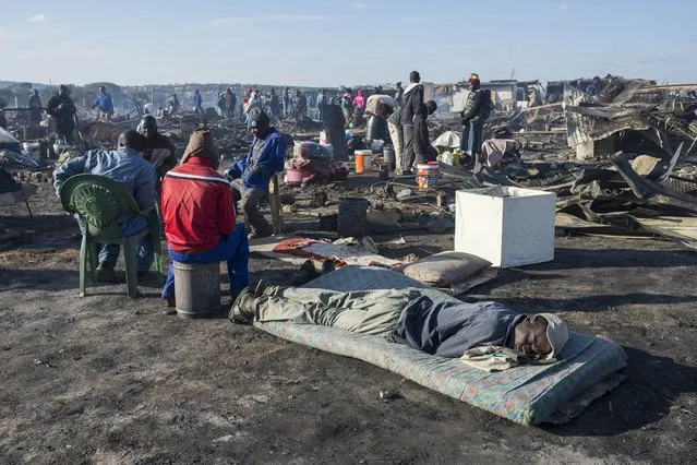 Residents of the Plastic View informal settlement after a huge fire destroyed over 200 homes in the slum area east of the South African city Pretoria on July 3, 2016. Five people died due to the fire and at least 1,200 people have been left homeless. (Photo by Ihsaan Haffejee/Anadolu Agency/Getty Images)