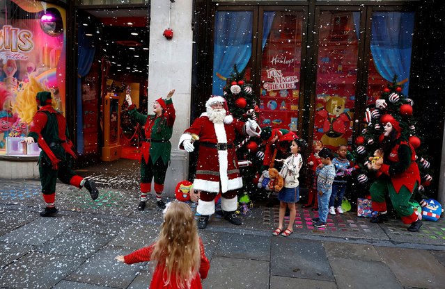 People dressed as Santa and his elves play with children invited to Hamleys toy store, as it announces its' potential top sellers for the Christmas season, in London, Britain on September 21, 2023. (Photo by Peter Nicholls/Reuters)