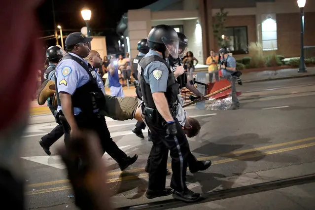 Police arrest a demonstrator protesting the acquittal of former St. Louis police officer Jason Stockley on September 16, 2017 in St. Louis, Missouri. Dozens of business windows were smashed and at least two police cars were damaged during a second day of protests following the acquittal of Stockley, who was been charged with first-degree murder last year following the 2011 on-duty shooting of Anthony Lamar Smith. (Photo by Scott Olson/Getty Images)