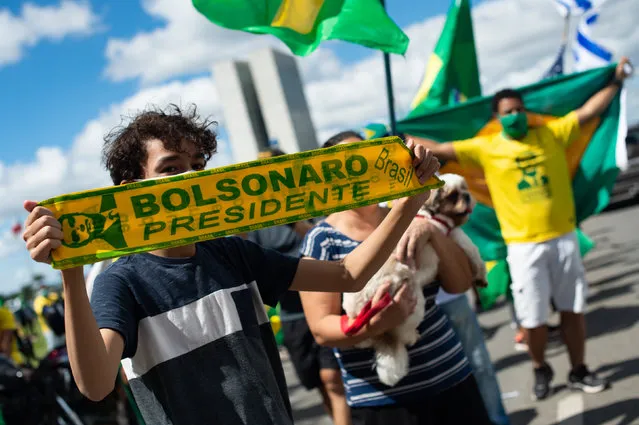 People participate in a motorcade and demonstration in favor Brazilian President Jair Bolsonaro amidst the outbreak of the coronavirus (COVID-19) in front the Brazilian Congress, on April 26, 2020 in Brasilia, Brazil. (Photo by Andressa Anholete/Getty Images)