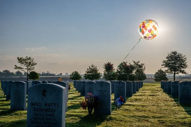 A birthday balloon is seen tied to a tombstone at the Houston National Cemetery on September 10, 2022 in Houston, Texas. People around Houston have begun visiting and preparing ahead of the 21st anniversary of the 9/11 terrorist attacks in New York City. Nearly 3,000 people were killed when terrorists hijacked four passenger planes and crashed them into the twin towers at the World Trade Center on September 11, 2001. (Photo by Brandon Bell/Getty Images)