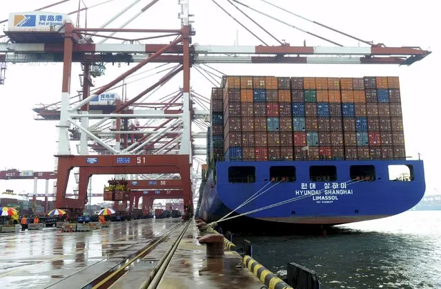 A cargo ship waits to be loaded with shipping containers at a port in Qingdao, Shandong province, China, September 1, 2015. China's August exports fell less than expected but a steeper slide in imports pointed to continuing economic weakness, adding to concerns over the health of the world's second-largest economy that have been rattling global markets. (Photo by Reuters/Stringer)