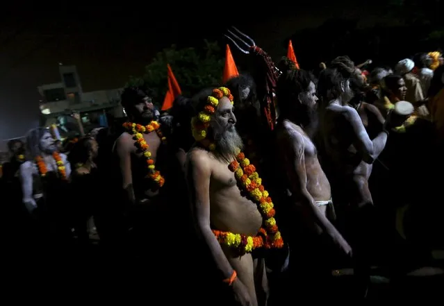 Naga Sadhus, or Hindu holy men, attend a procession before taking a dip in a holy pond during the second “Shahi Snan” (grand bath) at “Kumbh Mela”, or Pitcher Festival, in Trimbakeshwar, India, September 13, 2015. (Photo by Danish Siddiqui/Reuters)