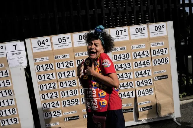 A supporters of former Brazilian President Luiz Inacio Lula da Silva, who is running for president again, reacts at a polling station during a presidential run-off election in Sao Paulo, Brazil, Sunday, October 30, 2022. (Photo by Matias Delacroix/AP Photo)