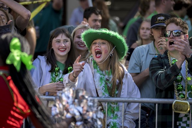 A group of local residents shout at group of cheerleaders during the St. Patrick's Day parade, Monday, March 17, 2025, in Savannah, Ga. (Photo by Stephen B. Morton/AP Photo)