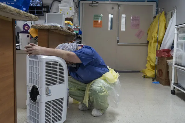 A medical staff member rests in front of a fan in the Covid-19 intensive care unit at the United Memorial Medical Center on June 30, 2020 in Houston, Texas. Covid-19 cases and hospitalizations have spiked since Texas reopened, pushing intensive-care wards to full capacity and sparking concerns about a surge in fatalities as the virus spreads. (Photo by Go Nakamura/Getty Images)