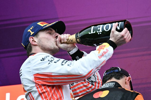 Red Bull Racing's Dutch driver Max Verstappen drinks champagne on the podium after winning the Formula One Japanese Grand Prix at the Suzuka circuit in Suzuka, Mie prefecture, Japan on April 6, 2025. (Photo by Philip Fong/AFP Photo)