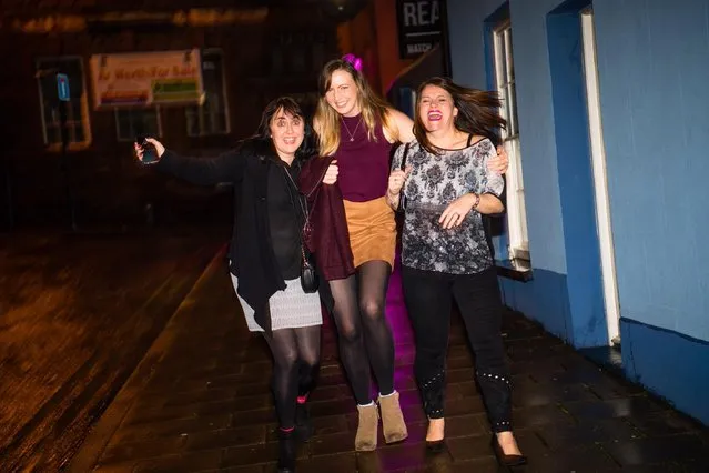 Revellers out and about in London, England on “Black Eye Friday” or “Mad Friday” on December 22, 2017. These three women head home after their office party in high spirits. (Photo by London News Pictures)