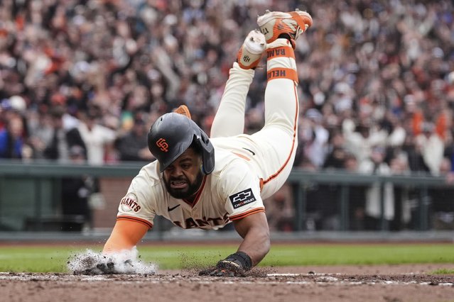 San Francisco Giants' Heliot Ramos scores the game-winning run on a throwing error Texas Rangers first baseman Jake Burger during the ninth inning of a baseball game Sunday, April 27, 2025, in San Francisco. (Photo by Godofredo A. Vásquez/AP Photo)