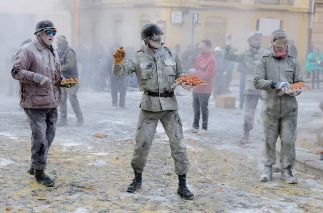 Revellers battle with flour and eggs during the traditional Els Enfarinats (The Floured) festival in Ibi, Alicante Province, Spain December 28, 2017. (Photo by Heino Kalis/Reuters)