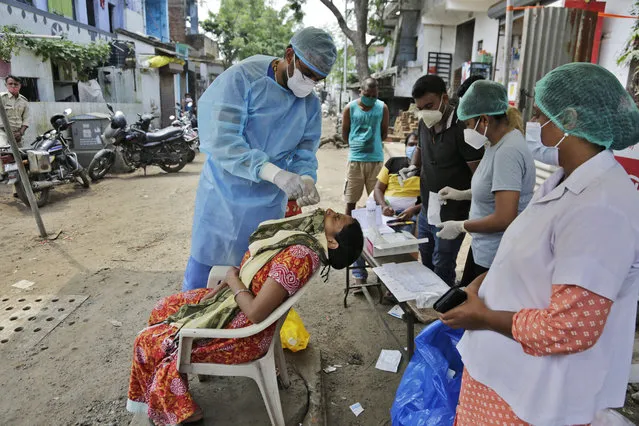 A health worker takes a nasal swab sample to test for COVID-19 in Ahmedabad, India, Sunday, September 6, 2020. India's coronavirus cases have crossed 4 million, leading the world in new infections and deepening misery in the country's vast hinterlands where surges have crippled the underfunded health care system (Photo by Ajit SolankiAP Photo)