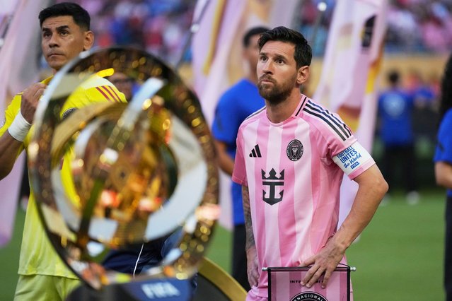 Inter Miami's Lionel Messi, right, and goalkeeper Oscar Ustari stand next to the trophy prior to the Club World Cup group A soccer match between Al Ahly and Inter Miami in Miami, Fla., Saturday, June 14, 2025. (Photo by Rebecca Blackwell/AP Photo)
