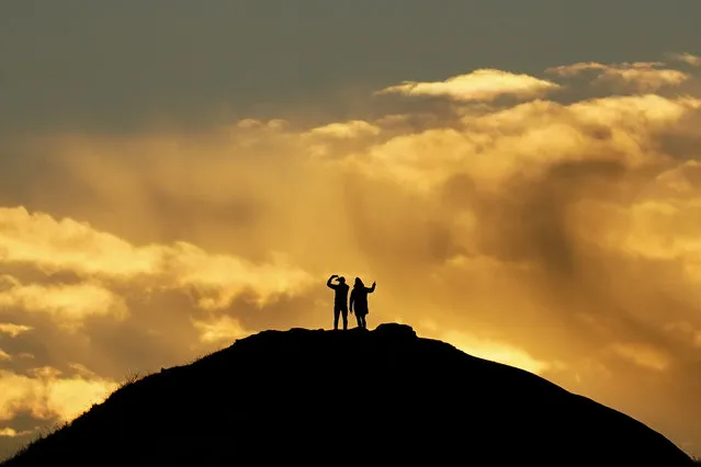 A couple stand on the top of a hill in Saltburn and watch the sunrise on the morning of the Winter Solstice on December 21, 2022 in Saltburn By The Sea, England. The winter solstice marks the date when the Earth’s axis rotates to the point that the north pole has its maximum tilt from the sun, delivering the shortest period of daylight in the year. While it is considered to be the first day of the astronomical winter season it can also be known as midwinter, because the days get longer after it has passed and the countdown to spring begins. (Photo by Ian Forsyth/Getty Images)