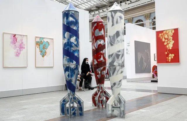 A woman seats near art works by Stano Filko on Galerie Emanuel Lay during the Cosmoscow international fair in Moscow, Russia, 10 September 2020. (Photo by Sergei Ilnitsky/EPA/EFE)