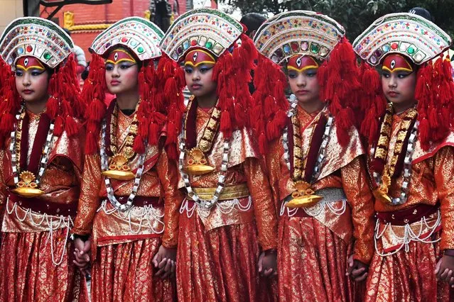Newar community girls dressed in a traditional attire take part in a procession to mark “Jyapu Day” celebrations which marks marks the end of the harvest season, in Kathmandu on December 8, 2022. (Photo by Prakash Mathema/AFP Photo)